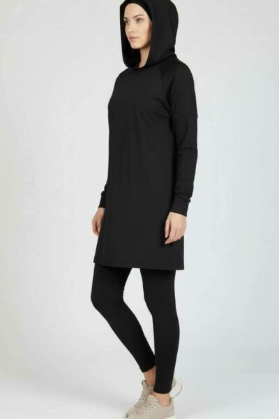 Tunique modeste noire HAYA portée de trois-quarts, coupe longue et fluide, idéale pour la mode modeste féminine.